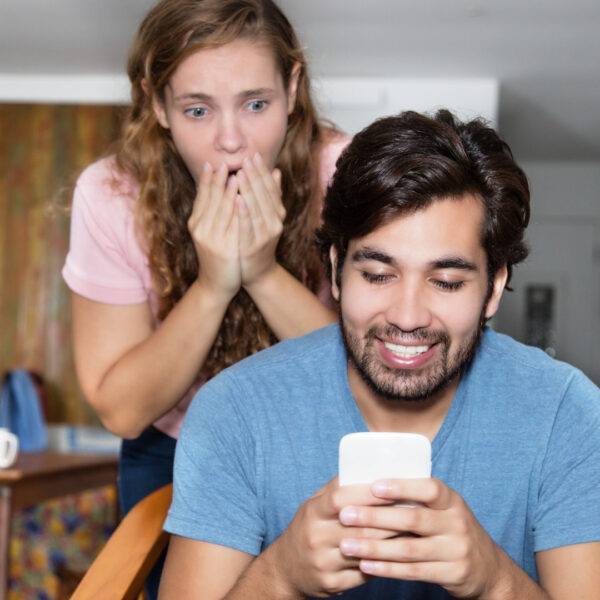 foster parents looking a message on phone shocked and excited