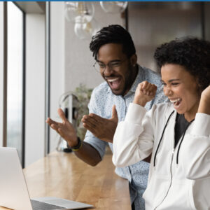 foster parents looking at computer excited about news