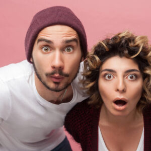 foster parents looking curiously shocked directly at camera is it good news